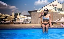 woman sitting near pool