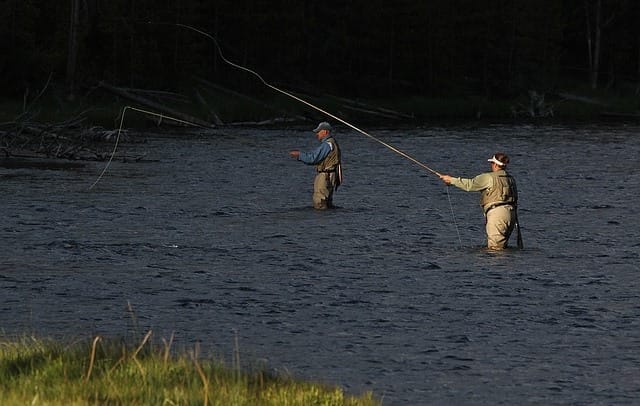 men fishing in a river